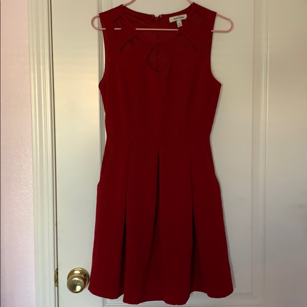 Red sleeveless dress with cutouts.